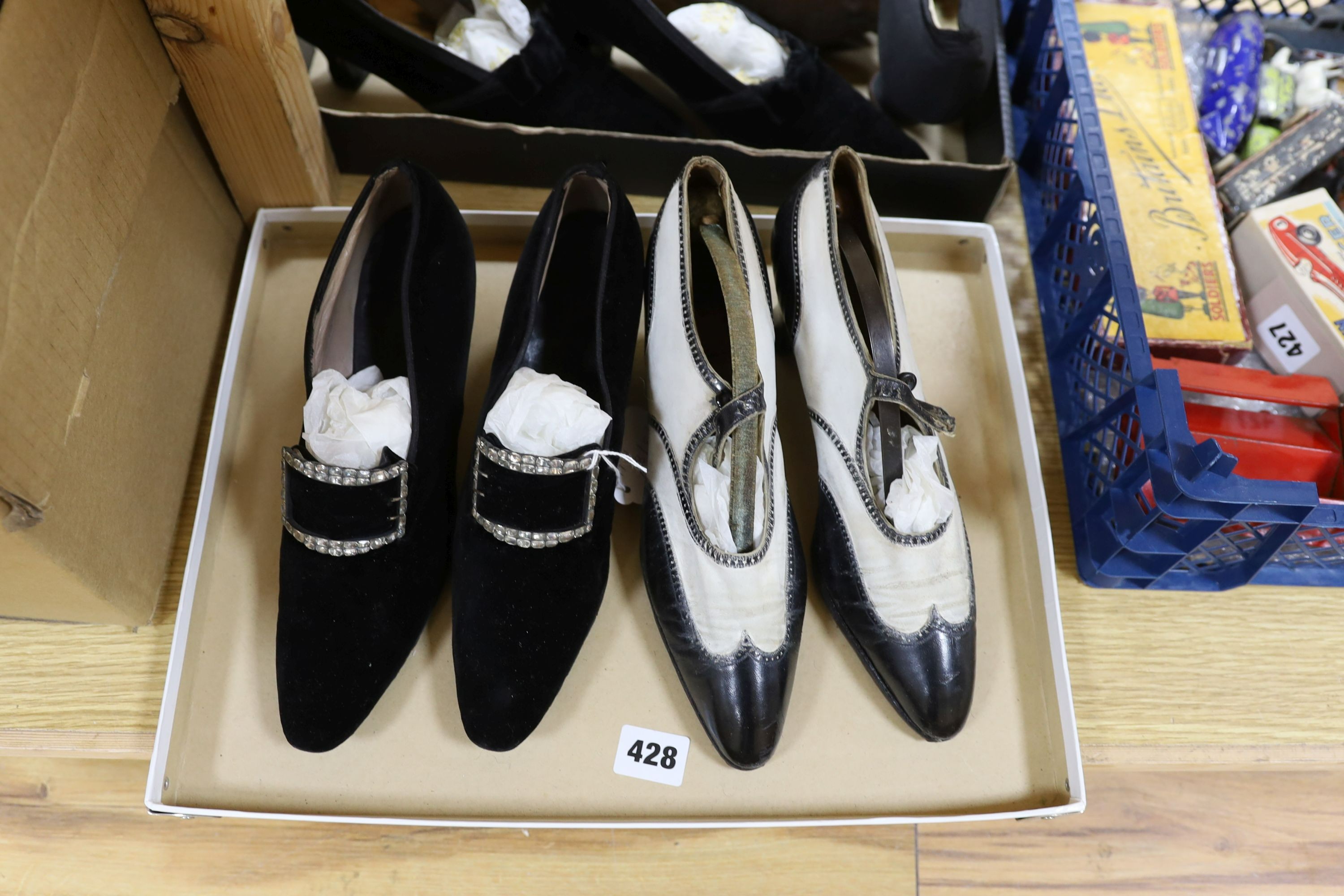 A pair of black velvet diamonte buckled shoes, a two-tone leather pair of shoes and three others